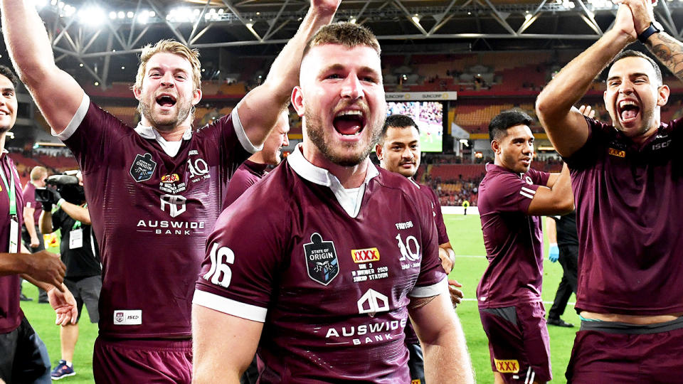 Jai Arrow (pictured middle) celebrates with teammates after winning State of Origin.