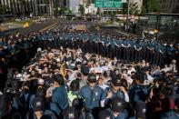 Anti-gay religious activists, surrounded by police, attempt to block the Seoul Queer Parade