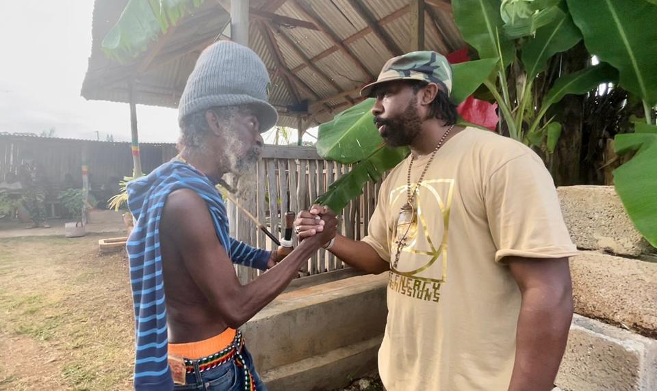 Athens hip-hop artist Amun Ra (right) locks arms with a man in Jamaica in this contributed photo from Oct. 2021. The family trip inspired Amun's new single, "Going Back to Jamaica," released on Jan. 25, 2022.