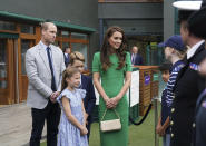 The Prince and Princess of Wales with Prince George and Princess Charlotte speak to ball boys and girls as they arrive on day fourteen of the 2023 Wimbledon Championships at the All England Lawn Tennis and Croquet Club in Wimbledon, Sunday July 16, 2023. (Victoria Jones/Pool photo via AP)