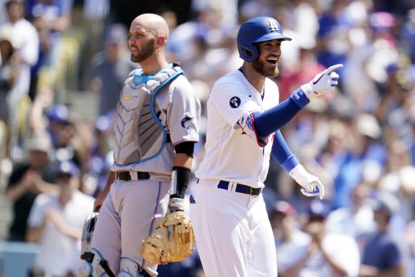 Los Angeles Dodgers' Cody Bellinger, right, celebrates next to Miami Marlins catcher Jacob Stallings.