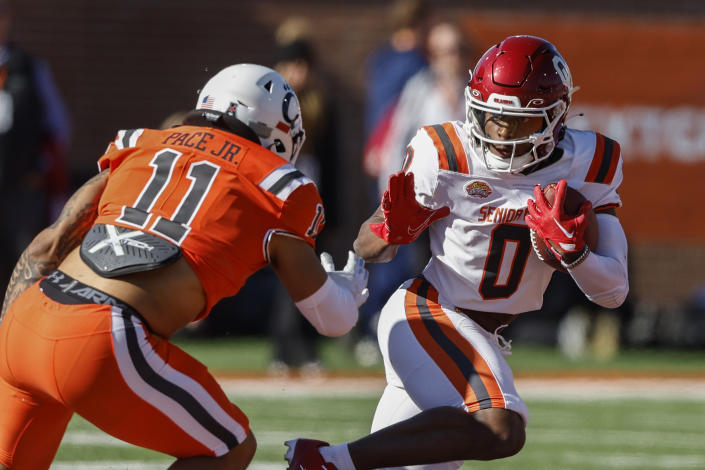 American running back Eric Gray of Oklahoma (0) carries the ball as National linebacker Ivan Pace Jr (11), of Cincinnati, defends during the first half of the Senior Bowl NCAA college football game, Saturday, Feb. 4, 2023, in Mobile, Ala.. (AP Photo/Butch Dill)