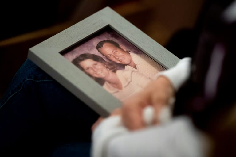 During a church vigil in Chico, California, for victims of the Camp Fire, Laura Martin holds a picture of TK Huff, her father who died in the blaze