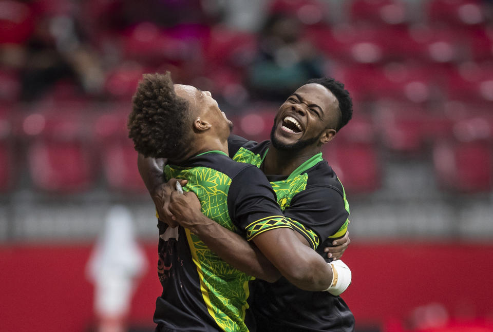 Jamaica's Jack Rampton, left, and Fabian Turner celebrate Rampton's try against Chile during an HSBC Canada Sevens rugby match in Vancouver, British Columbia, Sunday, Sept. 19, 2021. (Darryl Dyck/The Canadian Press via AP)