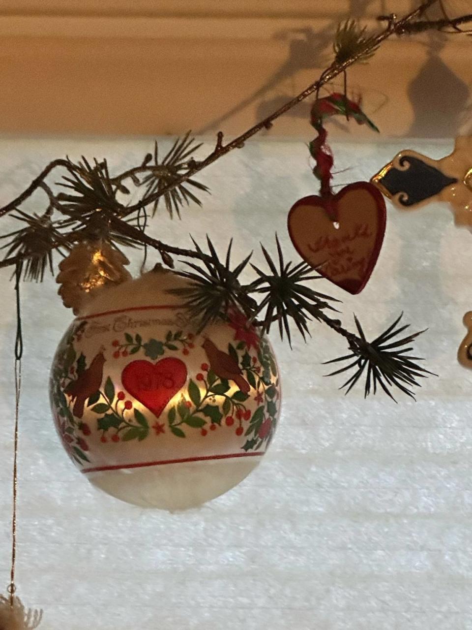 Ellen Binder and her husband have collected a new Christmas ornament every year they’ve been married, starting with this ball ornament featuring a heart. The heart-shaped ornament on the right came from a friend who was battling cancer.