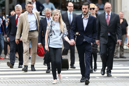 The parents of critically ill baby Charlie Gard, Connie Yates and Chris Gard, arrive at the High Court in London, Britain July 14, 2017. REUTERS/Neil Hall