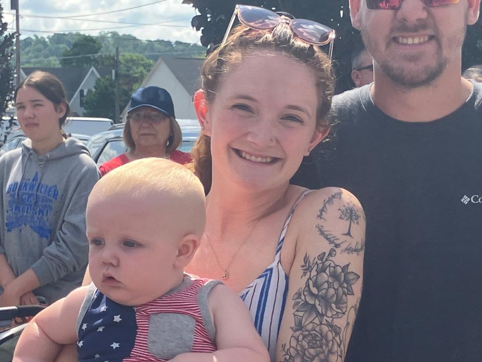 Brooke Maynard holds her 10-month-old son Kole during Tuesday's Liberty Fest parade in Bellville.