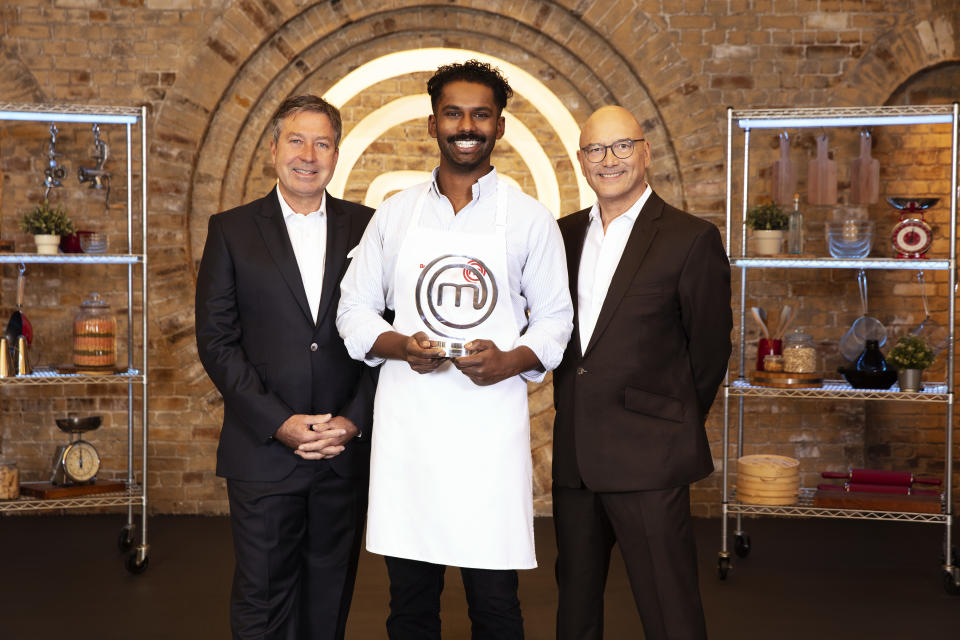 Brin Pirathapan was awarded the MasterChef trophy by judges John Torode and Gregg Wallace (Shine TV/BBC/PA)