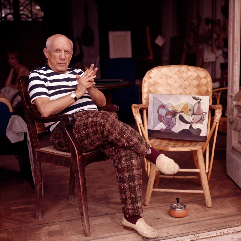 Pablo Picasso in a Breton and espadrilles at his home in Cannes, circa 1960 - Getty