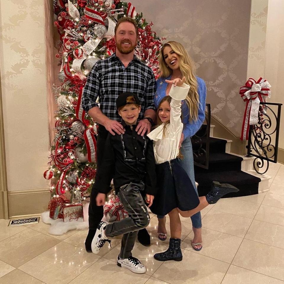 Kroy Biermann, Kim Zolciak-Biermann, with their kids, Kaia and Kane all smiling.