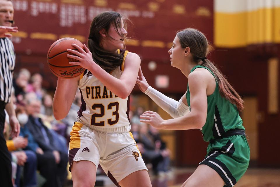 Southeast senior Cami McPeak looks for an open teammate as Mogadore sophomore Ari Tompkins guards her during Wednesday night’s game at Southeast High School.