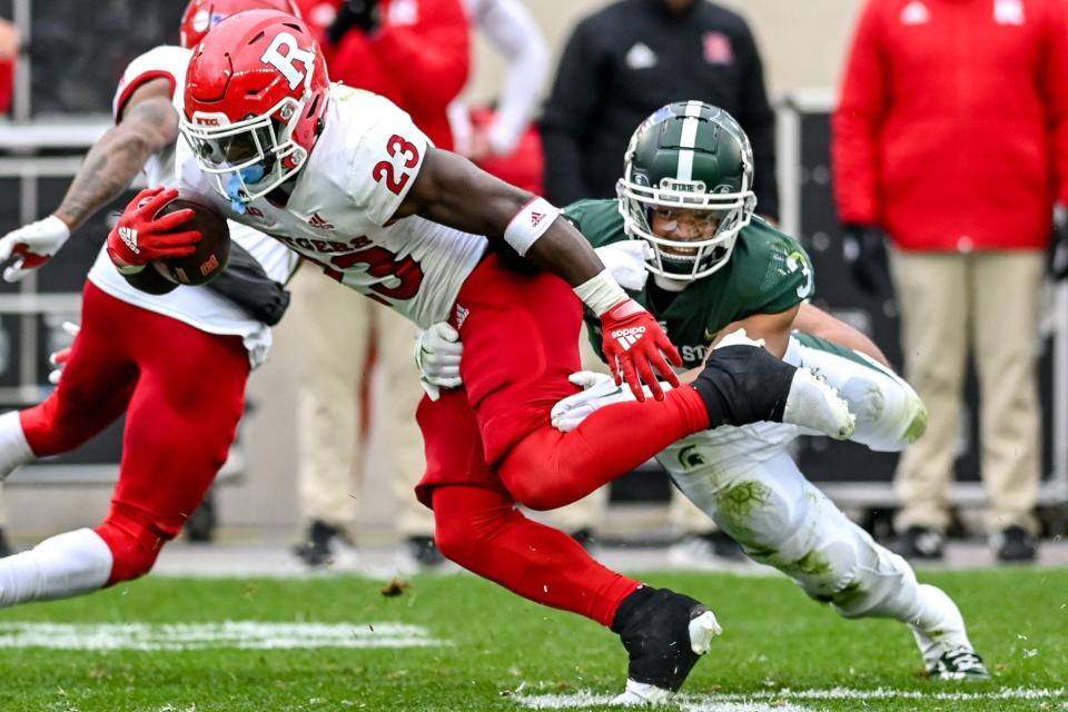 Michigan State's Xavier Henderson tackles Rutgers' Kyle Monangai during the second quarter on Saturday, Nov. 12, 2022, in East Lansing.