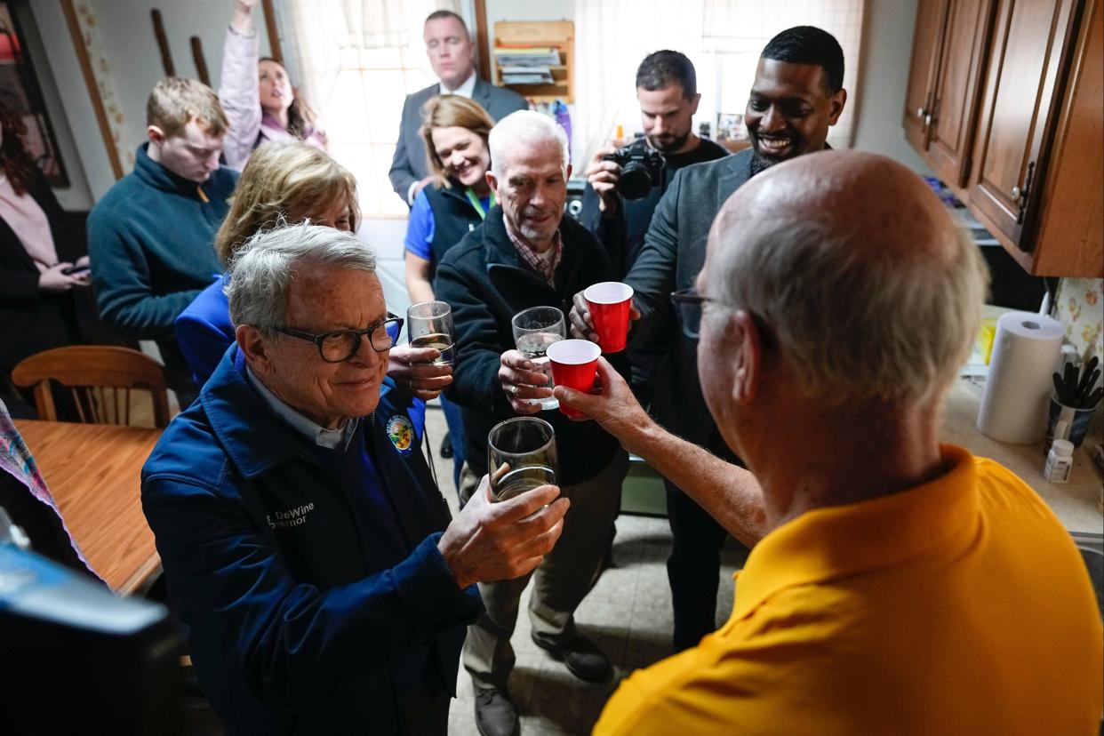 Ohio Governor Mike DeWine, Congressman Bill Johnson, EPA administrator Michael Regan toast a glass of tap water with East Palestine resident Andris Baltputnis, 79. Work continues to clean up the vinyl chloride chemical spill from the Norfolk Southern train derailment on Feb. 3.