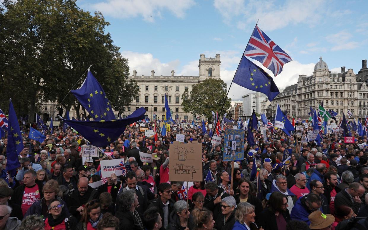 Demonstrators with placards and EU and Union flags gather in Parliament Square in central London - ISABEL INFANTES/AFP