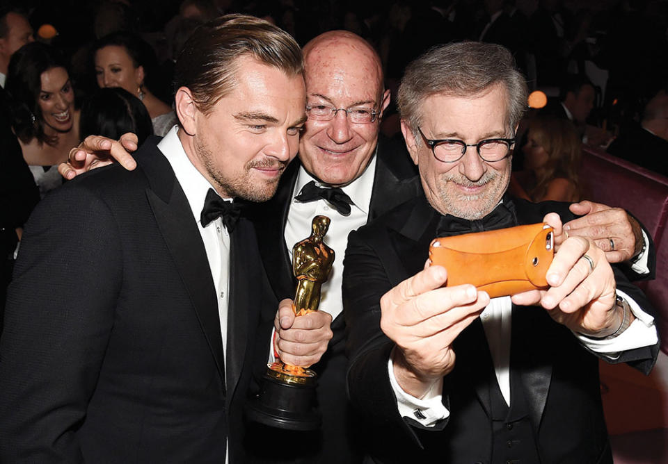 Leonardo DiCaprio, named best actor for wrestling a bear in The Revenant, joined that movie’s producer Arnon Milchan as Steven Spielberg took a selfie at the 2016 ball.