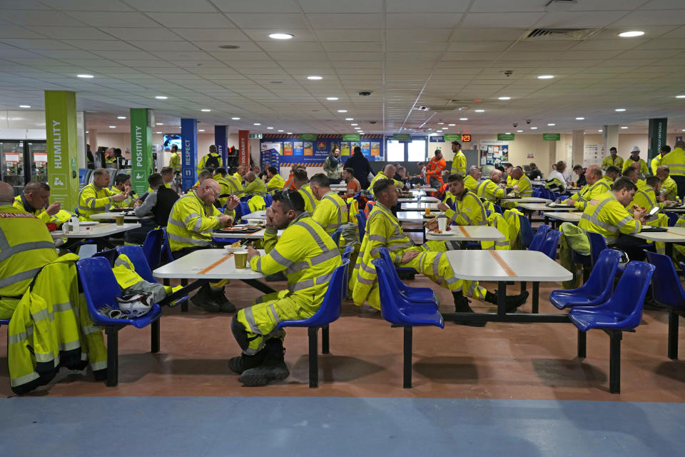 Workers have lunch at the canteen of the construction site of Hinkley Point C nuclear power station in Somerset, England, Tuesday, Oct. 11, 2022. Around 8,000 workers, many of them currently living on-site, work a 24-hour shift pattern seven days a week. (AP Photo/Kin Cheung)