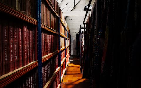 Books line the walls, charting different fabric patterns throughout the centuries - Credit: George Baxter