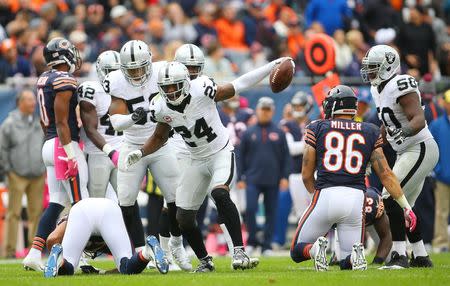 Oct 4, 2015; Chicago, IL, USA; Oakland Raiders free safety Charles Woodson (24) celebrates after an interception against the Chicago Bears during the second half at Soldier Field. Mandatory Credit: Jerry Lai-USA TODAY Sports