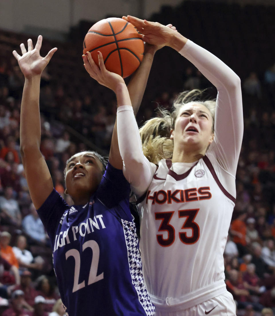 Virginia Tech's Elizabeth Kitley (33) goes to score past High Point's Shakira Baskerville (22) in the first half of an NCAA college basketball game in Blacksburg, Va., Monday, Nov. 6, 2023. (Matt Gentry/The Roanoke Times via AP)