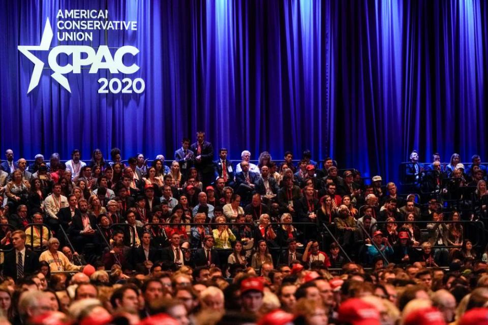 People listen as Mike Pence speaks at CPAC on 27 February 2020.