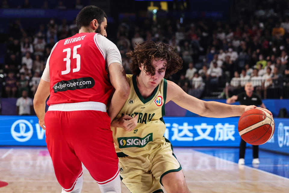 OKINAWA, JAPAN – SEPTEMBER 03: Josh Giddey #3 of Australia drives to the basket against <a class="link " href="https://sports.yahoo.com/nba/players/6206" data-i13n="sec:content-canvas;subsec:anchor_text;elm:context_link" data-ylk="slk:Goga Bitadze;sec:content-canvas;subsec:anchor_text;elm:context_link;itc:0">Goga Bitadze</a> #35 of Georgia during the FIBA Basketball World Cup 2nd Round Group K game between Australia and Georgia at Okinawa Arena on September 03, 2023 in Okinawa, Japan. (Photo by Takashi Aoyama/Getty Images)