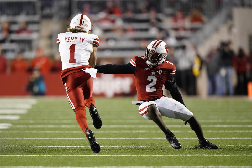 Nebraska's Billy Kemp IV (1) runs past Wisconsin's Ricardo Hallman (2) during the first half of an NCAA college football game Saturday, Nov. 18, 2023 in Madison, Wis. (AP Photo/Aaron Gash)