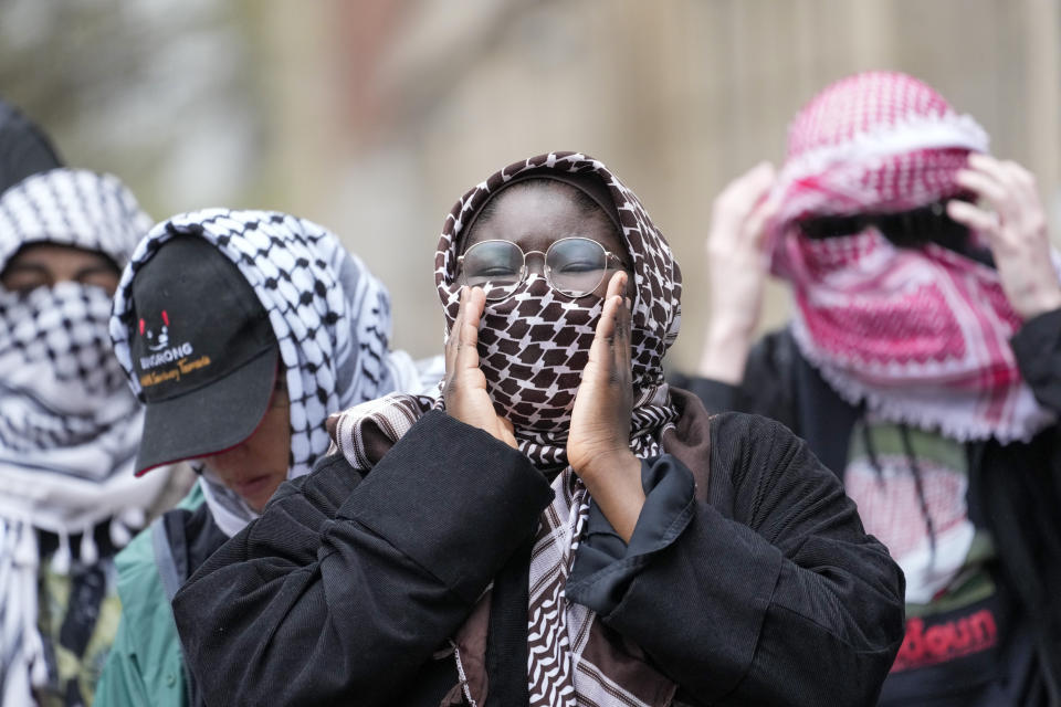 Demonstrators chant slogans outside the Columbia University campus, Thursday, April 18, 2024, in New York. The protesters were calling for the school to divest from corporations they claim profit from the war in the Middle East. (AP Photo/Mary Altaffer)