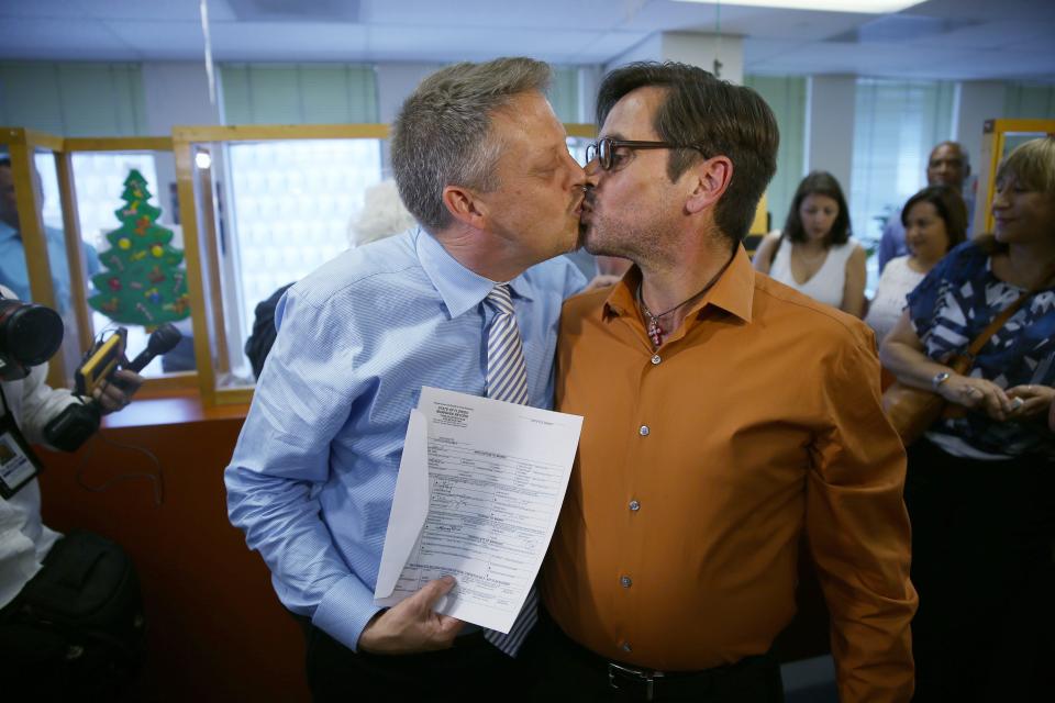 Don Johnston, left, and Jorge Diaz kiss after getting a marriage license from the Miami-Dade County Clerk of Courts on Jan. 5, 2015, in Miami.