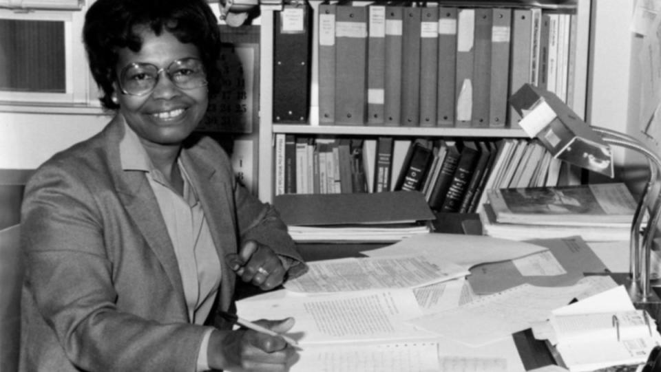 Dr. Gladys West sits at desk in undated black and white photo