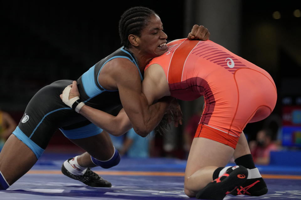Guinea's Fatoumata Yarie Camara, left, and Japan's Risako Kawai compete during the women's 57kg freestyle wrestling match at the 2020 Summer Olympics, Wednesday, Aug. 4, 2021 in Chiba, Japan. Camara is the only Guinean athlete to qualify for these Games. (AP Photo/Aaron Favila)