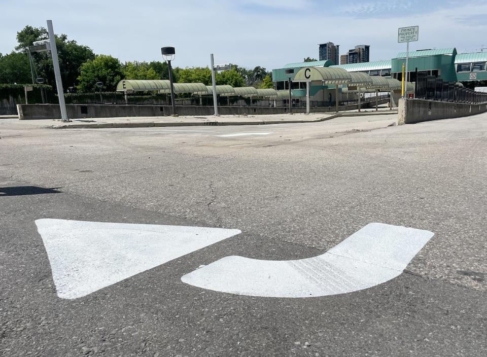 Arrows and lines to create parking spaces have been painted in the former bus lanes at the closed transit terminal in downtown Kitchener. The area will be used for parkin this summer, the region says.