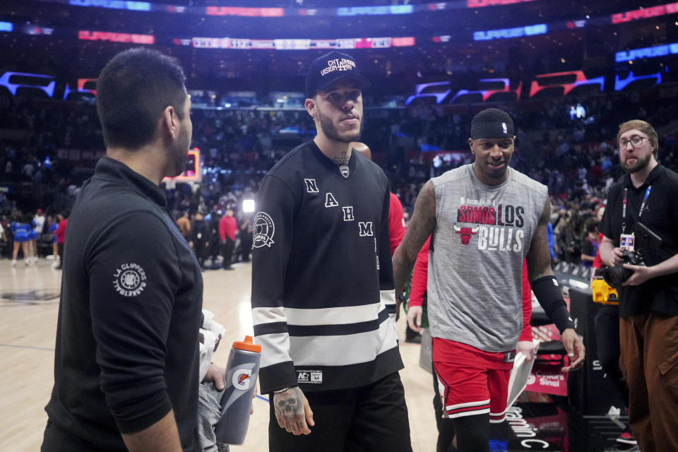 Chicago Bulls guard Lonzo Ball, center, walks off the court at the end of an NBA basketball game against the Los Angeles Clippers in Los Angeles, Saturday, March 9, 2024. Coach Billy Donovan said Ball has started sprinting and cutting during on-court drills in controlled, noncontact situations. Ball has not played since January 2022 because of three procedures on his left knee. (AP Photo/Eric Thayer)