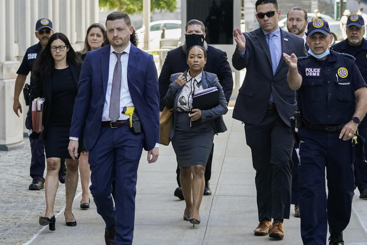 The prosecution team in the trial against R. Kelly is escorted by federal agents as they arrive at federal court, Wednesday, June 29, 2022, in the Brooklyn borough of New York. R&B star R. Kelly faces the possibility of a quarter century or more in prison when he is sentenced Wednesday in a federal sex trafficking case in New York. (AP Photo/John Minchillo)