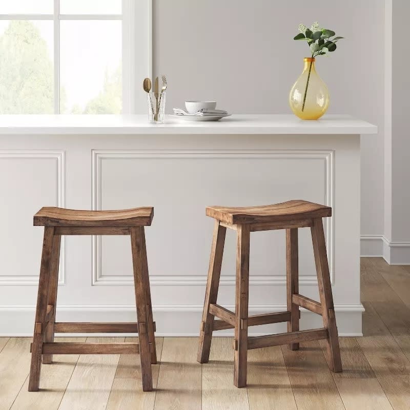 brown barstools in front of white counter