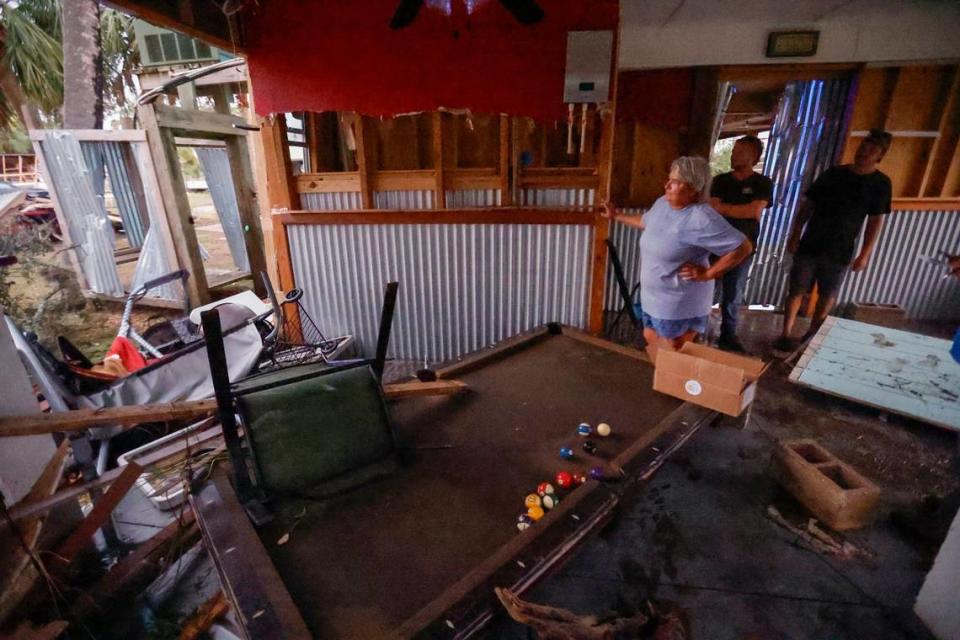 Hope Reinke looks out at the damage from the game room on the first floor of her home in Horseshoe Beach, Florida on Wednesday, August 30, 2023.
