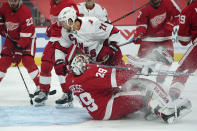 Carolina Hurricanes right wing Nino Niederreiter (21) scores on Detroit Red Wings goaltender Thomas Greiss (29) in the first period of an NHL hockey game Thursday, Jan. 14, 2021, in Detroit. (AP Photo/Paul Sancya)