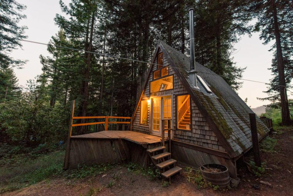 <h2>Cazadero, California</h2> <p><a rel="nofollow noopener" href="https://www.airbnb.com/rooms/2437969?s=oVS_wkpp" target="_blank" data-ylk="slk:This A-frame cabin;elm:context_link;itc:0;sec:content-canvas" class="link ">This A-frame cabin</a> in western Sonoma County is modest in size, but it just might be the rustic and romantic getaway you've been dreaming about this winter. The rental includes a stylishly renovated interior complete with a freestanding fireplace and fully stocked bookshelves.</p> <h4>Airbnb</h4>