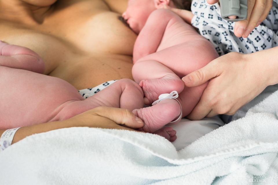 "This midwife helping this mother breastfeed newborn twins, between the tangle of wires and tiny legs."