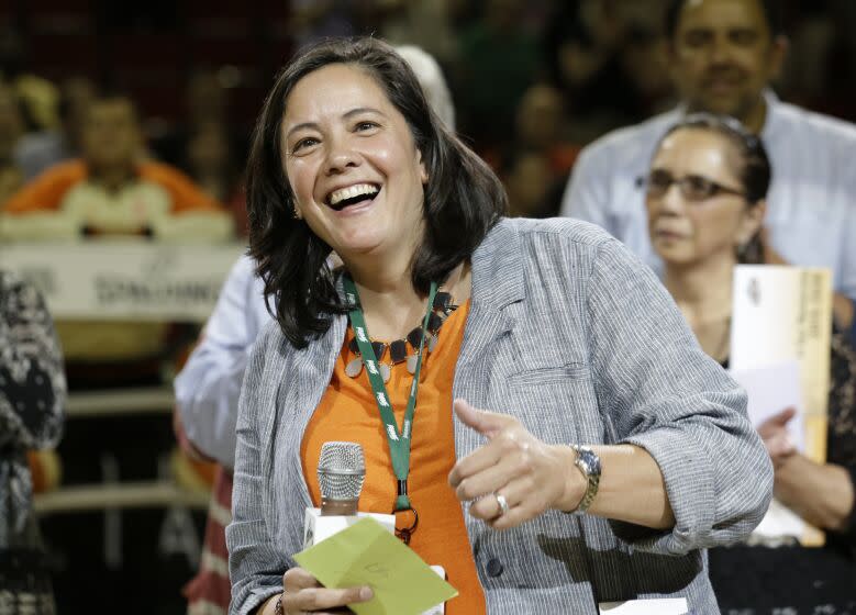 Outgoing Seattle Storm CEO and president Karen Bryant smiles as she is honored on her last day before a WNBA basketball game