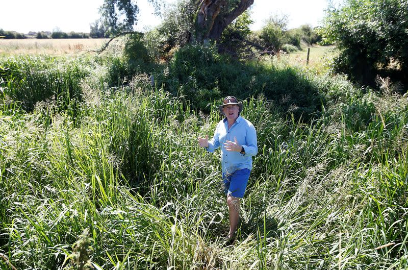 Alisdair Naulls of The Rivers Trust stands at the edge of the River Thames, in Cricklade