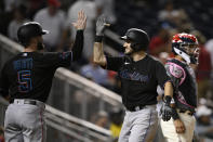 Miami Marlins' Garrett Hampson, right, celebrates his two-run home run with Jon Berti (5) during the 11th inning of a baseball game against the Washington Nationals, Friday, Sept. 1, 2023, in Washington. (AP Photo/Nick Wass)