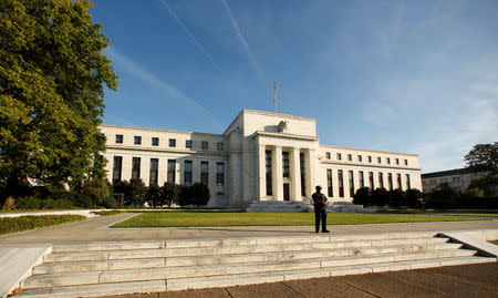 FILE PHOTO: A police officer keeps watch in front of the U.S. Federal Reserve building in Washington, DC, U.S. on October 12, 2016. REUTERS/Kevin Lamarque/File Photo