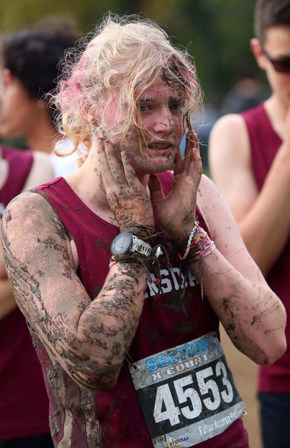 ScarsdaleÕs Maria Roberts cleans some of the mud off her face after finishing the Girls Varsity III race in the Section 1 Coaches Cross-Country Invitational at Bowdoin Park in Wappingers Falls Oct. 21, 2023.