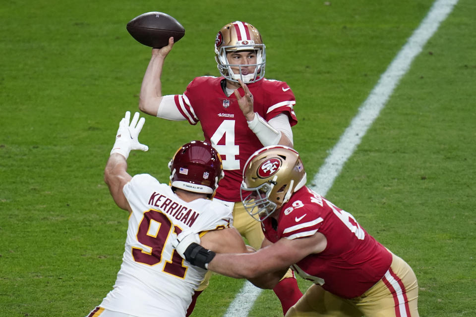 San Francisco 49ers quarterback Nick Mullens (4) throws under pressure from Washington Football Team defensive end Ryan Kerrigan (91) during the first half of an NFL football game, Sunday, Dec. 13, 2020, in Glendale, Ariz. (AP Photo/Ross D. Franklin)