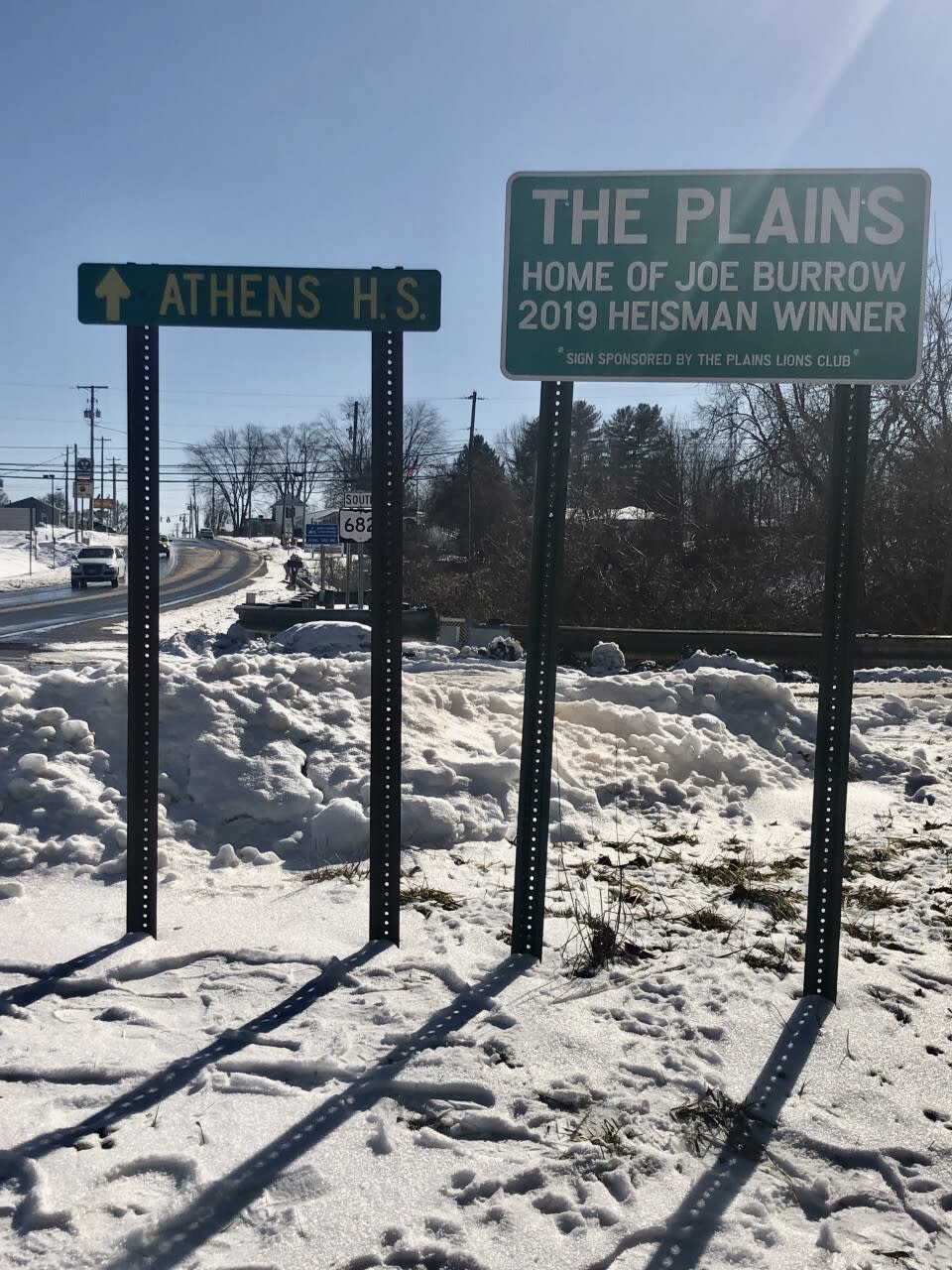 Road signs welcome people driving into The Plains, Ohio, Joe Burrow's hometown.