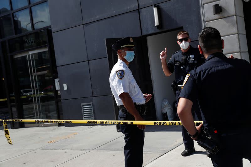 NYPD officers speak at crime scene at 265 Houston Street, where Fahim Saleh, Co-founder/CEO of Gokada, was found dead at the apartment building in New York City