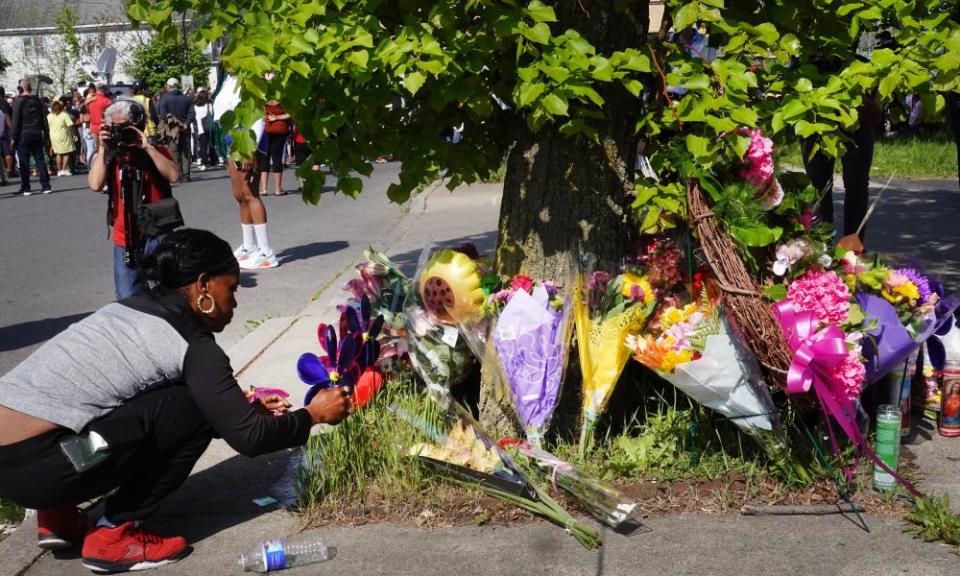 Flowers are left at a makeshift memorial outside of Tops market in Buffalo, New York, after a gunman opened fire, killing 10 people and wounding another three, on Saturday.