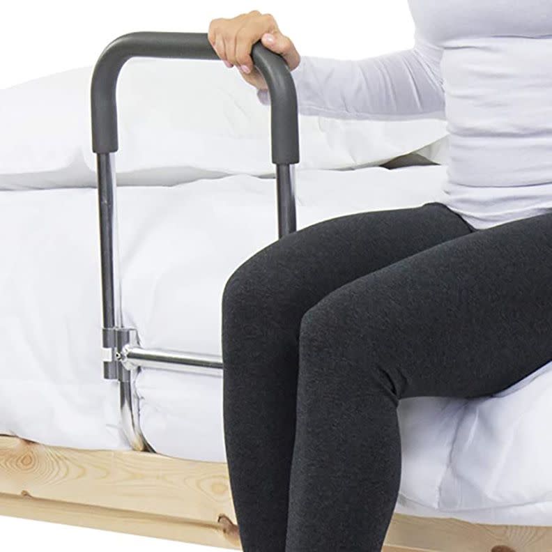 Woman using a bed rail.