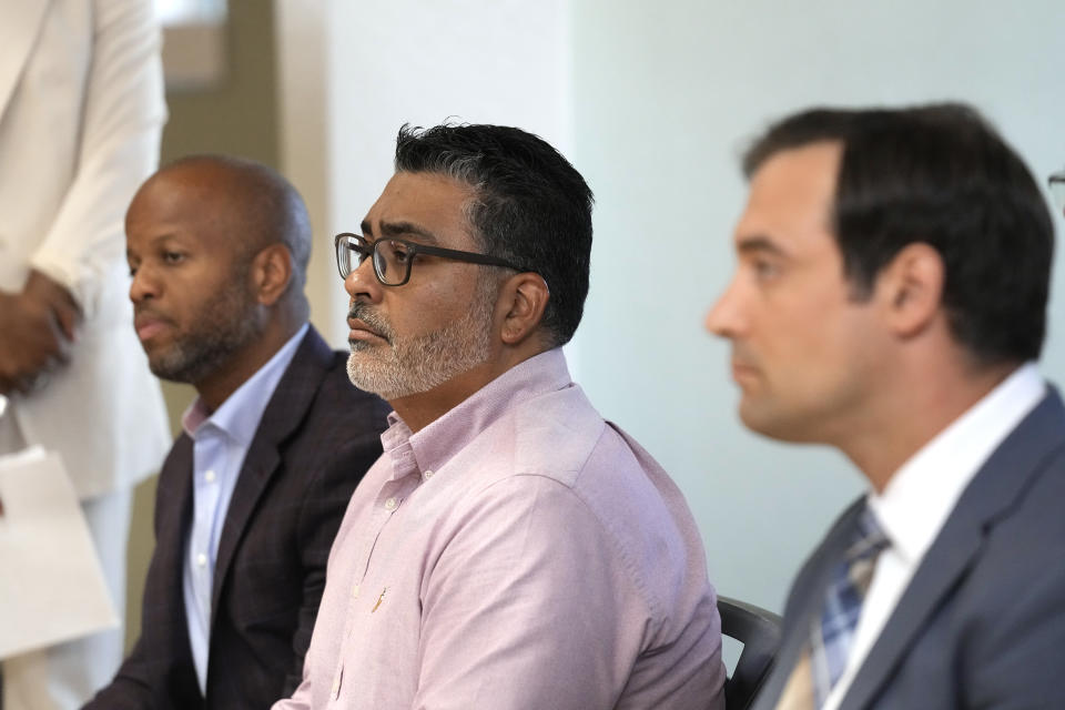 Gabe Lavine, right, Arizona Department of Emergency and Military Affairs Director, Division of Emergency Management, Dr. Eugene Livar, center, Arizona Department of Health Services Chief Heat Officer, and City of Tempe Mayor Corey Woods, left, listen to guest speakers during a news conference held by the Arizona Department of Health Services and Governor's Office of Resiliency ahead of Heat Awareness Week at the Escalante Multi-Generational Center Friday, May 3, 2024, in Tempe, Ariz. (AP Photo/Ross D. Franklin)