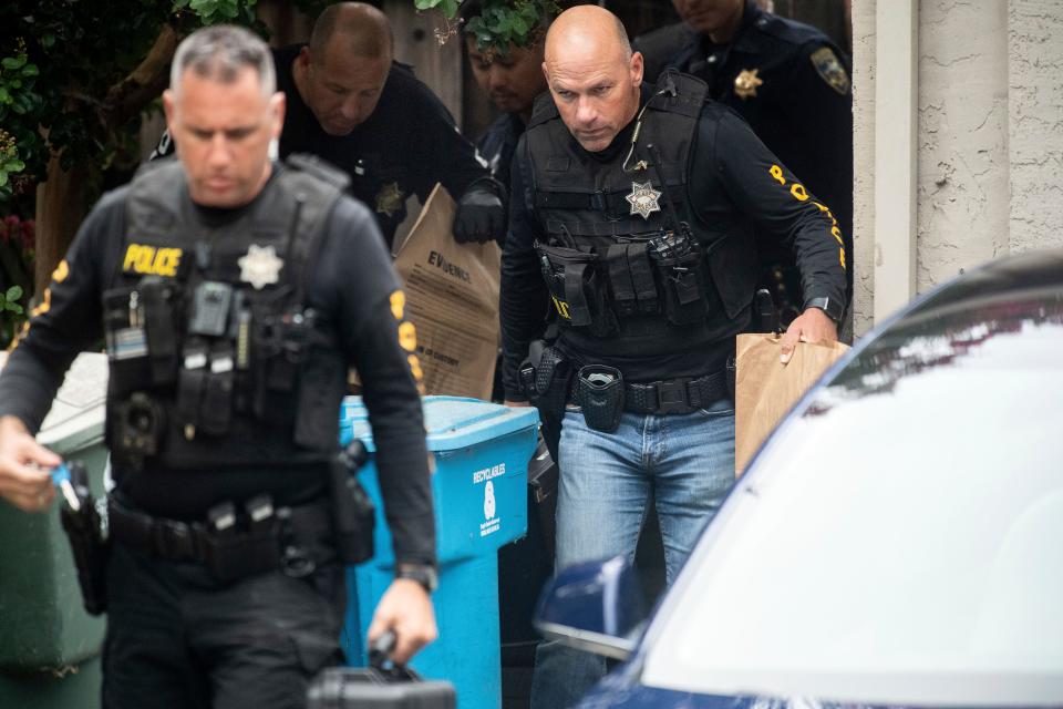 Police officers carry evidence bags from the family home of the suspected Gilroy Garlic Festival gunman in Gilroy, Calif.